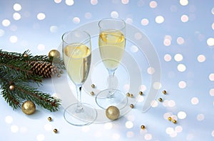 Christmas  branches and cones, two glasses of champagne. Christmas decor