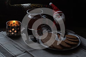 Christmas breakfast. Tea and gingerbread cookies plate, candle andsoft toy Santa