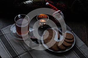 Christmas breakfast. Tea and gingerbread cookies plate, candle andsoft toy Santa