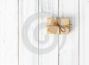 Christmas brown gift box on white wood background,flat lay