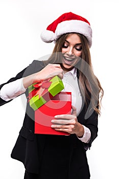 Christmas business Woman open Gift Box with happy emotion. Beautiful Brunette Girl in Santa Hat isolated. Portrait