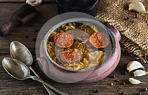 Christmas cabbage soup in ceramic bowl on natural wooden background