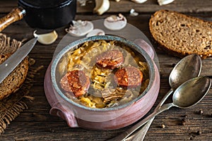 Christmas cabbage soup in ceramic bowl on natural wooden background