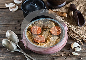 Christmas cabbage soup in ceramic bowl on natural wooden background