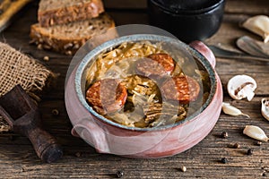 Christmas cabbage soup in ceramic bowl on natural wooden background