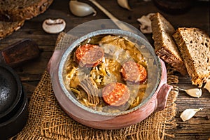 Christmas cabbage soup in ceramic bowl on natural wooden background