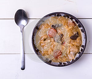 Christmas cabbage soup with mushrooms on white background.