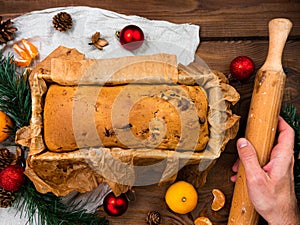 Christmas cake baking rolling pin in hand rustic wooden background flatlay Dough recipe ingredient eggs wholegrain flour