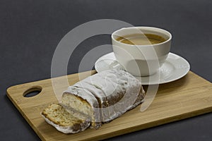 Christmas cake and cup of kafe on the cutting board