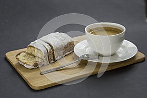 Christmas cake and cup of kafe on the cutting board