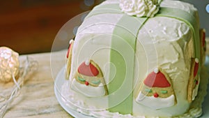 Christmas cake with gingerbread cookies in the shape of Santa Claus