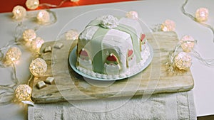 Christmas cake with gingerbread cookies in the shape of Santa Claus