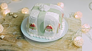 Christmas cake with gingerbread cookies in the shape of Santa Claus