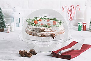 Christmas cake on glass stand decorated with rosemary dried berries