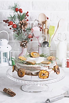 Christmas cake glass stand decorated with rosemary dried mandarin slices