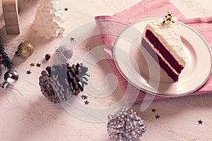 Christmas cake on plate on red fabric on wood background and dec