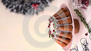 Christmas cake topped with sugar icing, cranberry and rosemary