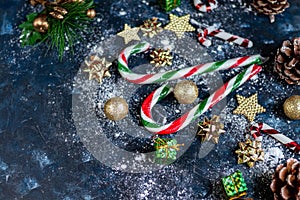 Christmas candies, caramel canes on a dark background.