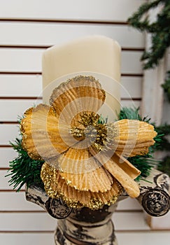 Christmas candle with decoration. Close up of a candle decorated with golden flower