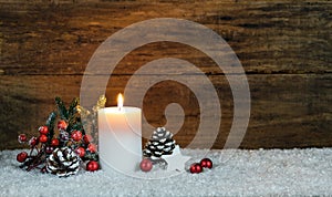 Christmas candle decoration with pine cone, fir tree, red berries, star and red christmas baubles