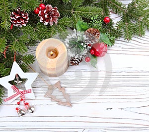 Christmas candle and decorations on white wooden table with copy