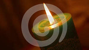 Christmas candle fire closeup with blurred background in Dutch angle