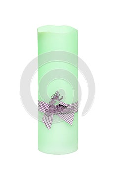 Christmas candle isolated. Closeup of a light green xmas candle with a light gray ribbon bow isolated on a white background.