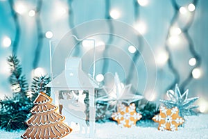 Christmas candle lantern and Christmas tree branches, snow, gingerbread, snowflakes and decorations