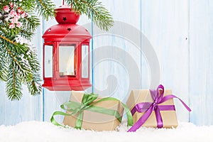 Christmas candle lantern, gift boxes and fir tree