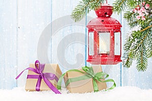 Christmas candle lantern, gift boxes and fir tree