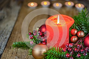 Christmas candle with natural decoration and ornaments