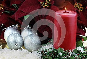 Christmas Candle and Poinsettias photo