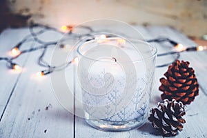 Christmas candle and rustic decoration on wood table