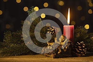 Christmas candle with statuette of baby Jesus