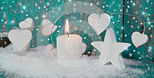 Christmas candle in white with turquoise hearts, wood and snow f