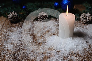 Christmas candle on a wooden background