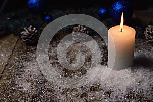 Christmas candle on a wooden background