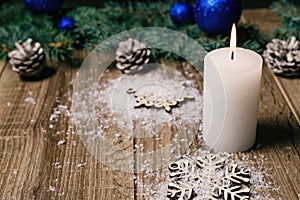 Christmas candle on a wooden background