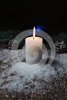 Christmas candle on a wooden background