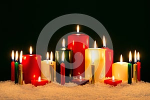 Christmas candles against black background.