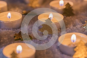Christmas candles with golden christmas trees elements on snow at night