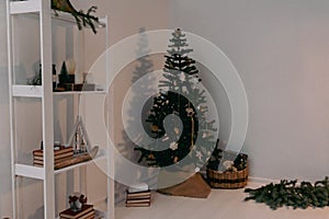 Christmas candles are lit on the shelves next to decorative Christmas trees and books.