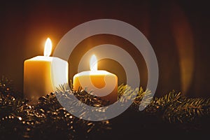 Christmas candles and ornaments over dark background with lights