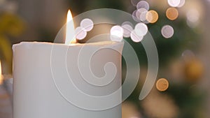 Christmas candles and ornaments over dark background with lights