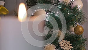 Christmas candles and ornaments over dark background with lights