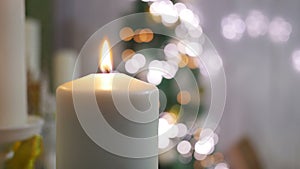 Christmas candles and ornaments over dark background with lights