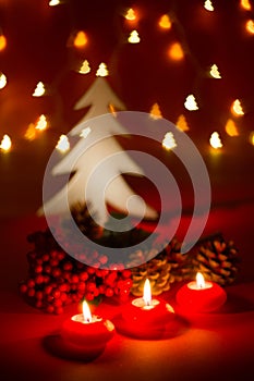 Christmas candles and ornaments over dark background with shaped bokeh lights
