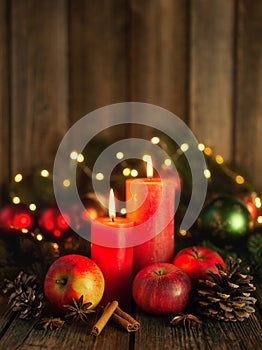 Christmas candles, red apples, cones and spices