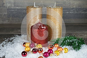 Christmas, candles in the snow with colorful balls