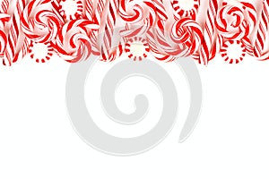 Christmas candy border with peppermints and candy canes over white